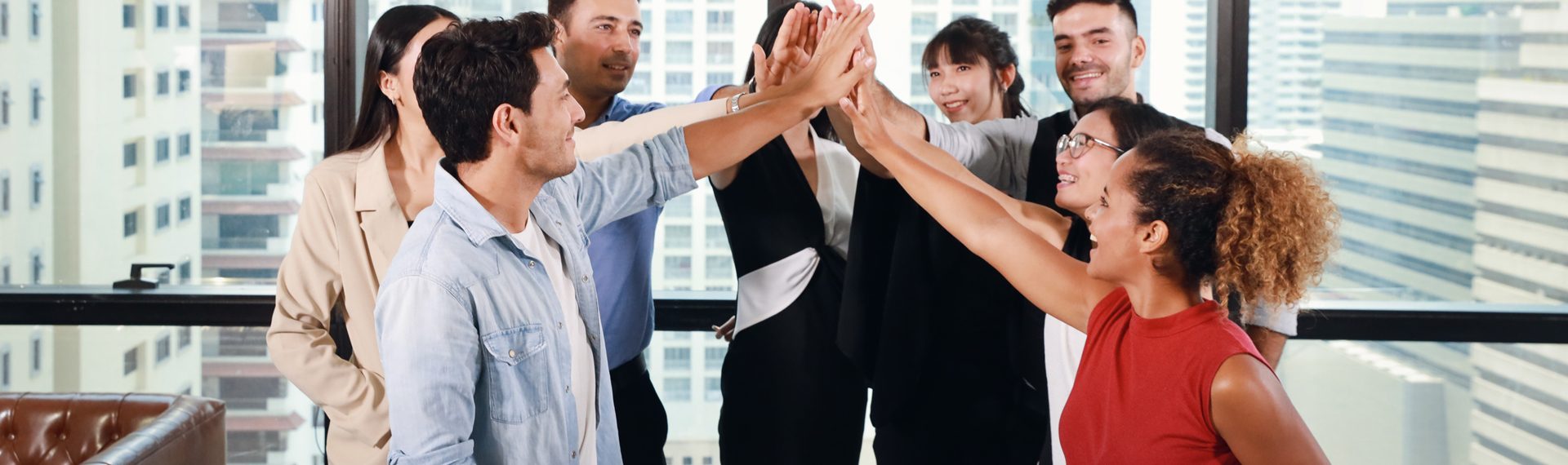 Close up of multiethnic business people stacking hands together meaning of teamwork concept